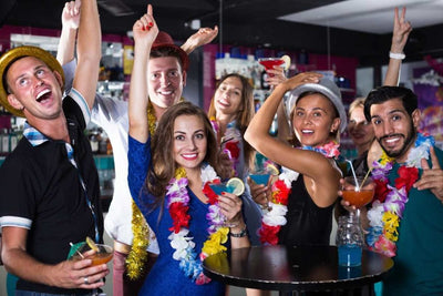 A group of people celebrating at a themed party, smiling and posing.