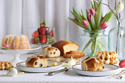 Easter desserts on a table with flowers.